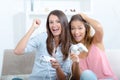 Happy women with joystick playing video games