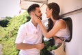 Happy young woman leaning out of trailer window to hug her boyfriend. Camping vacation Royalty Free Stock Photo