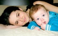 Happy woman with little baby smiling and playing games