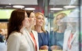 Happy women looking at jewelry shop window in mall Royalty Free Stock Photo