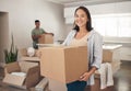 Happy, woman and moving box in new house for property, investment and real estate in living room. Female person, smile Royalty Free Stock Photo