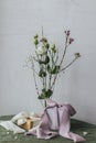 Happy women\'s day and mother\'s day . Stylish gift with silk ribbons and modern tender bouquet against rustic wall.