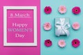 Happy Women`s Day Pastel Candy Colours Background. Floral womens day flat lay with beautifully wrapped present.