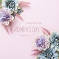 Happy Women`s Day Pastel Pink Colored Background. Flat lay floral greeting card with beautiful silk flowers. Royalty Free Stock Photo