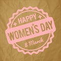 Happy Women`s Day rubber stamp baby pink on a crumpled paper brown background. Royalty Free Stock Photo