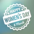 Happy Women`s Day rubber stamp white on a blue bokeh fog background. Royalty Free Stock Photo