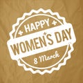 Happy Women`s Day rubber stamp white on a crumpled paper brown background. Royalty Free Stock Photo