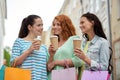 Happy women with shopping bags and coffee in city Royalty Free Stock Photo