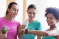 Happy women showing time on wrist watch in gym Royalty Free Stock Photo