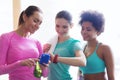 Happy women showing time on wrist watch in gym Royalty Free Stock Photo