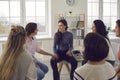 Happy women sitting in circle, smiling, talking and sharing positivity in group meeting Royalty Free Stock Photo