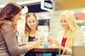 Happy women with smartphones and shopping bags Royalty Free Stock Photo