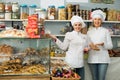 Happy women staff offering sweets Royalty Free Stock Photo