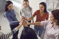 Happy women standing in circle, joining hands and smiling, feeling united and empowered Royalty Free Stock Photo