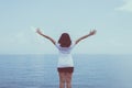 Happy woman standing with with open hands at sea,Enjoying in Nature,Freedom concept Royalty Free Stock Photo