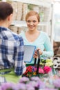 Happy women with tablet pc at flower shop Royalty Free Stock Photo