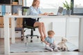 Smiling lady and calm kid in office