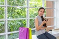 Happy women using Mobile Phone and tablet sitting in coffee shop. Female working with tablet using social network. Asian people. s Royalty Free Stock Photo