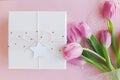 Happy womens day. 8 march. Happy Mothers day. Pink tulips bouquet and gift box on pink background flat lay. Greeting card. Gentle