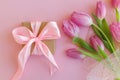 Happy womens day. 8 march. Pink tulips bouquet and gift box on pink background flat lay. Happy Mothers day. Greeting card. Gentle