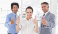 Happy work team giving thumbs up Royalty Free Stock Photo