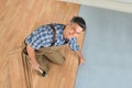 Happy worker assembling new laminate floor Royalty Free Stock Photo
