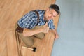 Happy worker assembling new laminate floor Royalty Free Stock Photo