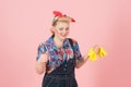 Happy worker girl with wrench and gloves. Teeth smiling woman ready to repair. Pin-up styled blonde girl with instruments
