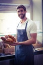 happy worker holding a basket of croissant Royalty Free Stock Photo