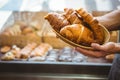 happy worker holding a basket of croissant Royalty Free Stock Photo