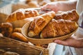 happy worker holding a basket of croissant Royalty Free Stock Photo