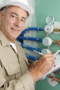 happy worker reading water meters in house Royalty Free Stock Photo