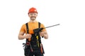 Happy worker - repairman or builder with construction tool - hammer drill percussion perforator in uniform Royalty Free Stock Photo