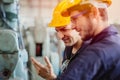 Happy worker, smiling industrial technician engineer enjoy working together with coworker Royalty Free Stock Photo