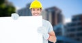 Happy worker wearing hardhat while holding blank bill board Royalty Free Stock Photo