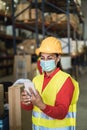 Happy worker women using mobile phone inside warehouse - Focus on face Royalty Free Stock Photo