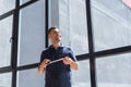 happy workman standing near large windows