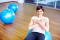 Happy with the workout. Portrait of happy woman doing sit ups on pilates ball. Royalty Free Stock Photo