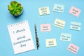 Happy World Compliment Day. Office desk with plant, notebook, pen and paper slips with compliments text for office worker such as Royalty Free Stock Photo