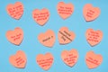 Happy World Compliment Day. Pink paper stickers in heart shape with text of popular compliments for beautiful lady on blue pastel