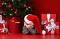 Happy xmas and New Year. Portrait of child in Santa red hat waiting for Christmas gifts. Royalty Free Stock Photo