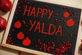 Happy Yalda night. Iranian traditional holiday. Pomegranate inscription on blackboard, flat lay