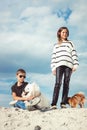 Happy 11 year old boy hugging his dog breed Samoyed at the seashore against a blue sky close up. Best friends rest and Royalty Free Stock Photo