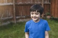 Happy 6-7 year old boy smiling and showing his missing teeth. Cute child boy lost front milk tooth. Kid having fun playing with Royalty Free Stock Photo