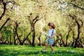 Happy 3 years old child boy catching butterflies with net on the walk in sunny garden or park