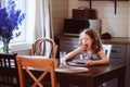 Happy 8 years old child girl having breakfast in country kitchen Royalty Free Stock Photo