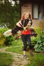 Happy 8 years old child girl playing with her spaniel dog outdoor Royalty Free Stock Photo