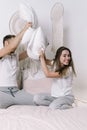 Young adult boyfriend and girlfriend spending morning in bedroom Royalty Free Stock Photo