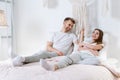 Young adult boyfriend and girlfriend spending morning in bedroom Royalty Free Stock Photo