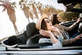 Happy young adult couple enjoying summer vacation driving a cabriolet car Royalty Free Stock Photo